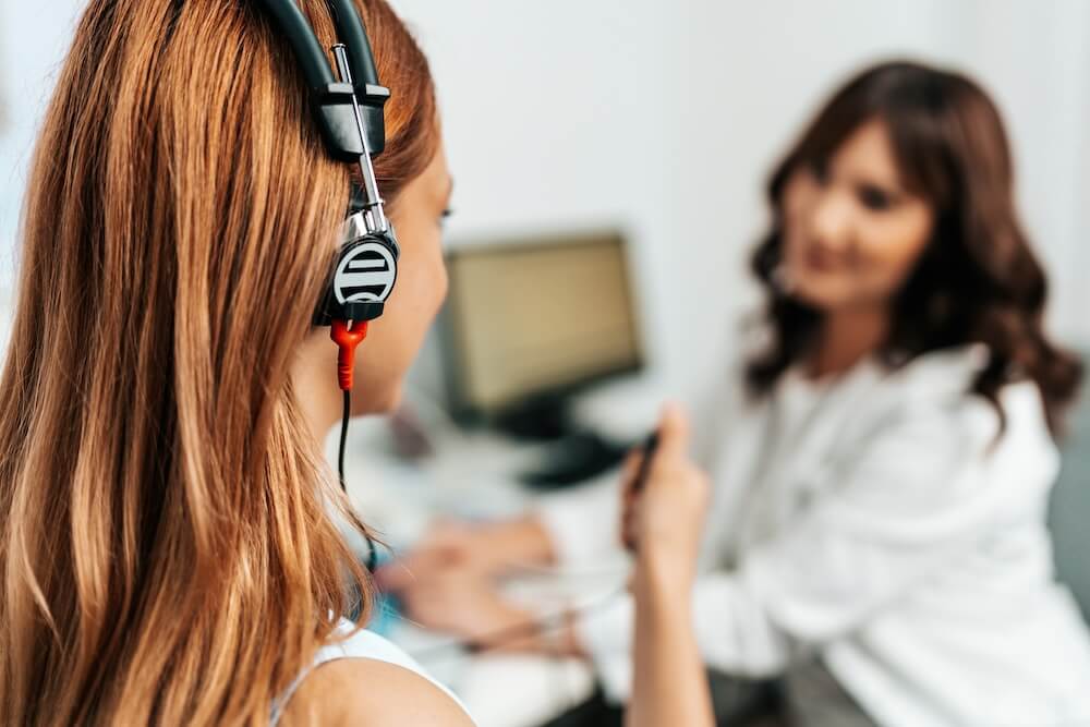 A girl taking an audiometry test