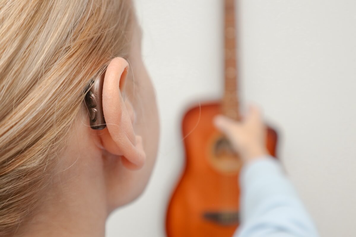 A girl wearing behind-the-ear hearing aids