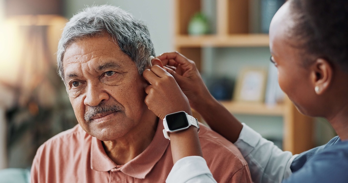 older man getting fitted for a hearing aid